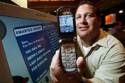 
Eric M. Blumberg, president of Smarter Agent, demonstrates how his program can transmit real estate information to the user's cell phone. 
 (The Spokesman-Review)
