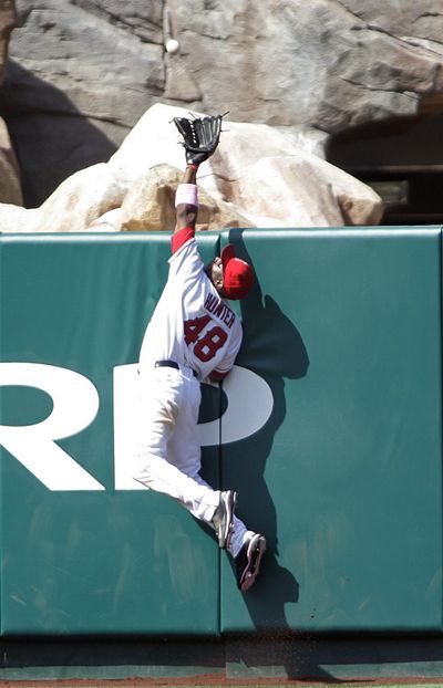 Angel center fielder Torii Hunter saves a home run.  (Associated Press / The Spokesman-Review)