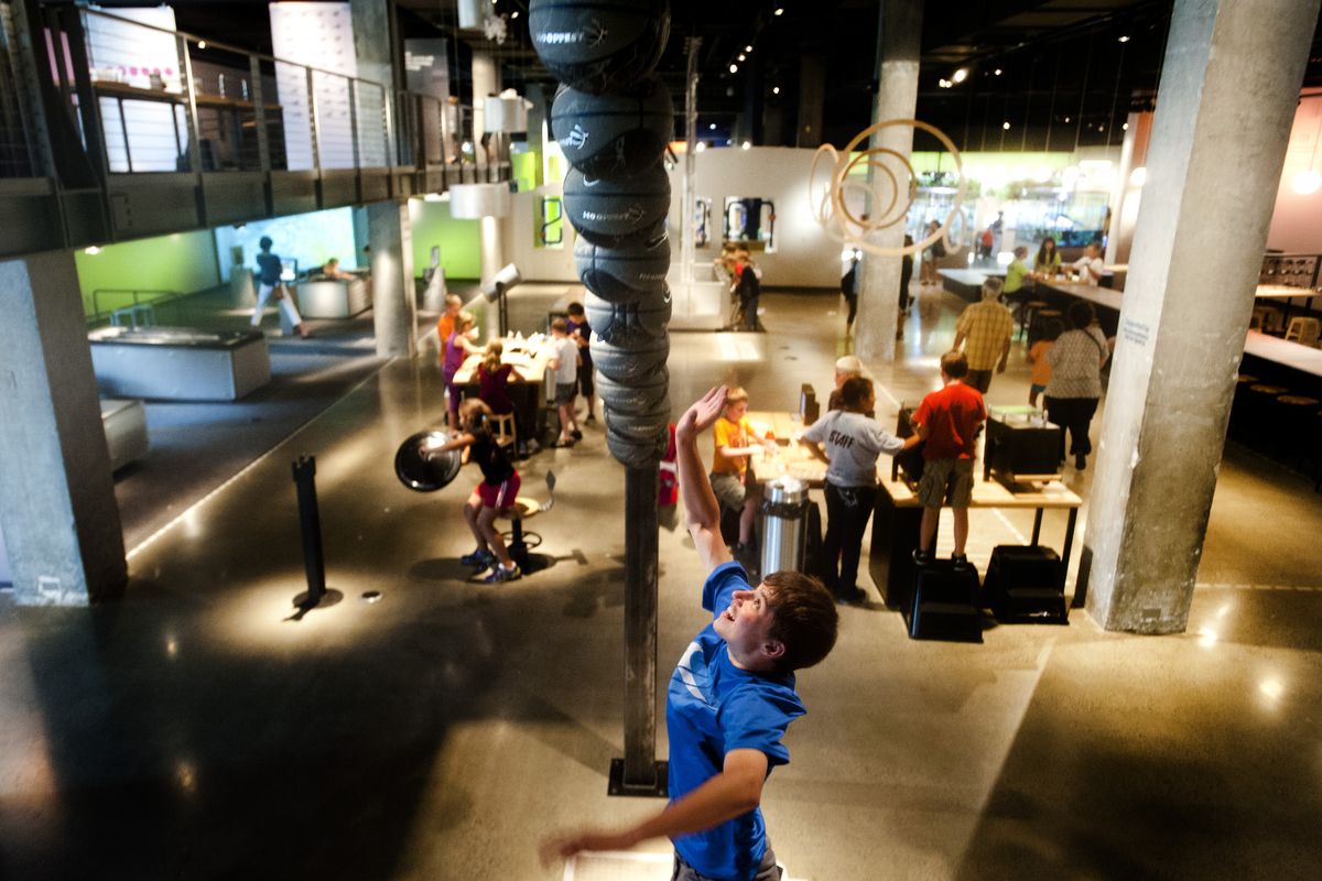 Grayson Druffel, of Eugene, leaps to touch a basketball in part of the exhibit “Jump-Time” in 2013 at Mobius Science Center in Spokane. (File)