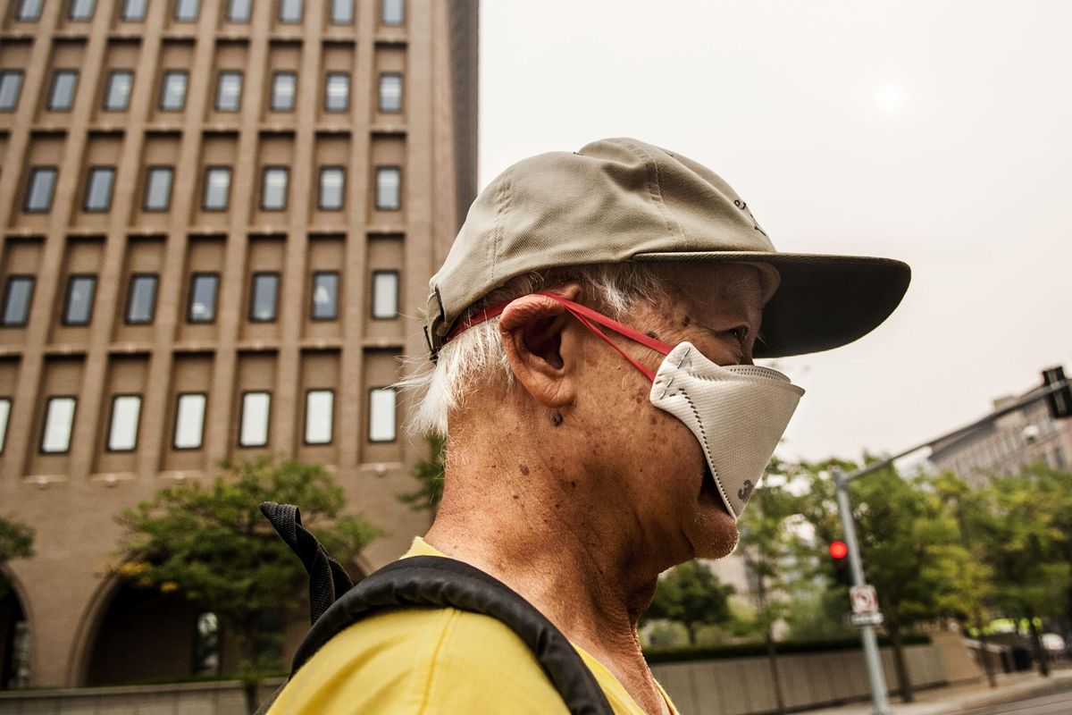 "I can stay indoors or I can wear a mask," said Bill Leong as he took his daily walk around a smoke filled Spokane on Tuesday, Sept. 5, 2017. (Kathy Plonka / The Spokesman-Review)