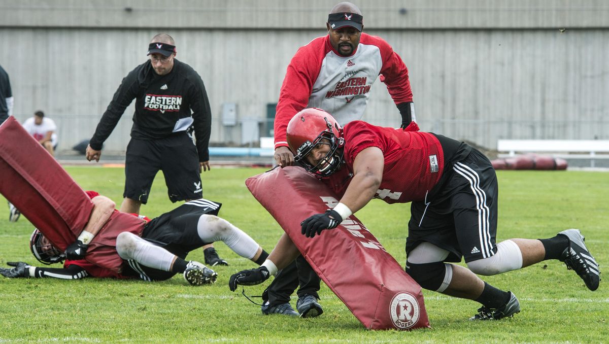 Easter Washington University defensive linemen Albert Havili, right, and Jack Sendelbach run through a tacking drill during the first fall practice on Tuesday. (Dan Pelle / The Spokesman-Review)