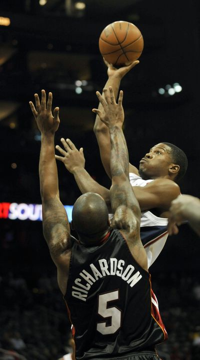 Joe Johnson, right, scored 30 points in Hawks’ NBA victory over Heat.  (Associated Press)