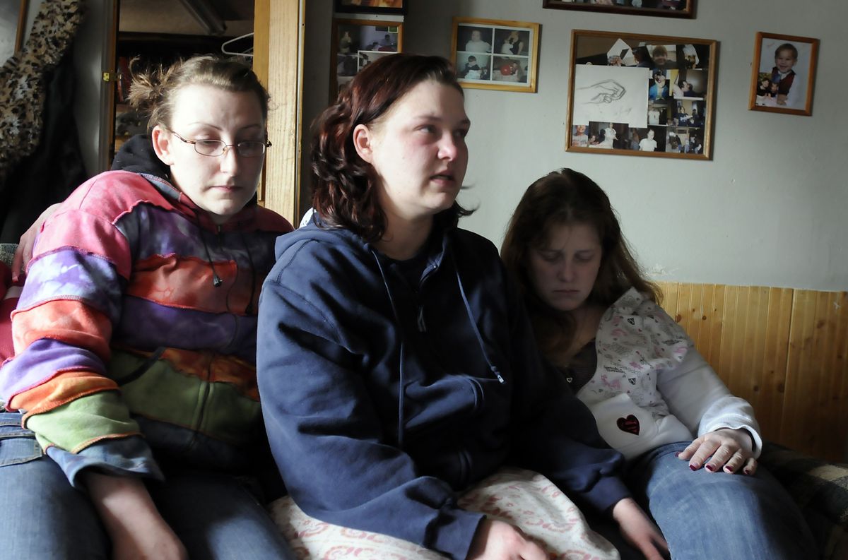 Misty Longest, center, talks about her brother, Johnnie Longest III, on Wednesday at her aunt’s home in Deer Park. At left is family friend Anna Swecker and at right is Charlie Barnes, another family friend. Johnnie Longest died after he was shot by police during a chase.  (Jesse Tinsley / The Spokesman-Review)