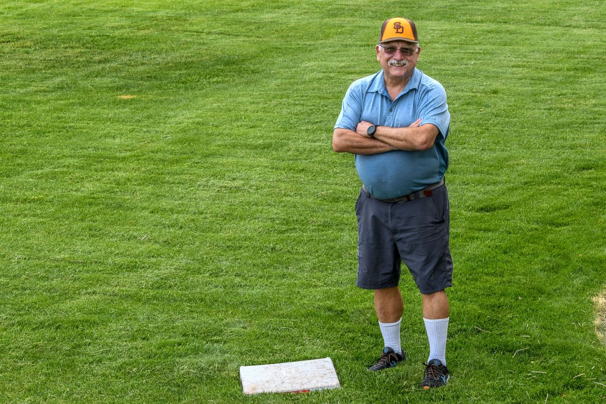 John Renzi of Spokane stands near the first base the he got from the Arizona Diamondbacks after their game against the Dodgers. He is photographed at his home on Wednesday, May 24, 2023. He is visiting every MLB stadium this summer.  (Kathy Plonka/The Spokesman-Review)