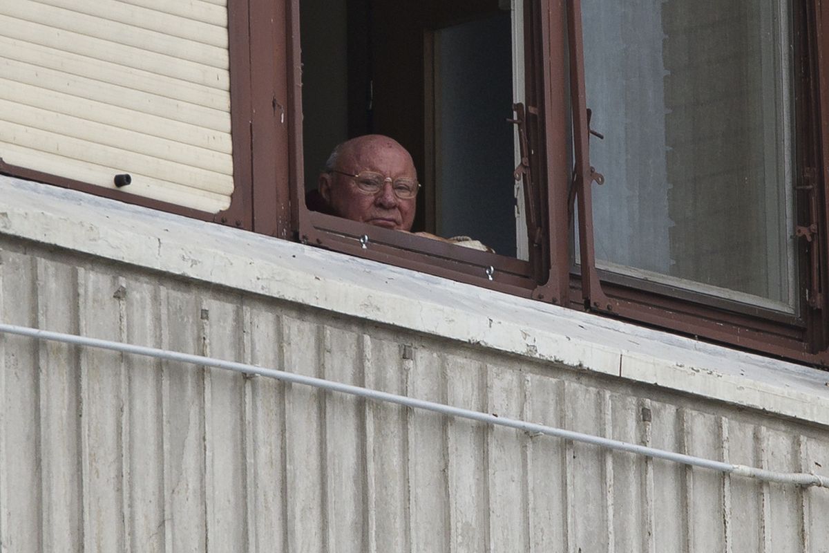 Jakob Denzinger looks from his apartment window in Osijek, eastern Croatia, on July 28. Denzinger is among dozens of suspected death camp guards and Nazi war criminals who collected millions of dollars in Social Security payments despite being forced out of the U.S. (Associated Press)