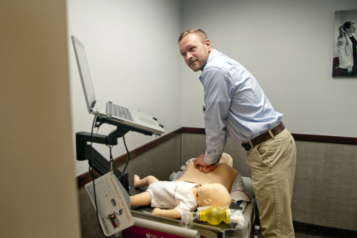 WSU medical student Michael Durrant monitors his progress as he practices his CPR skills at the WSU Virtual Clinical Center in Spokane on Wednesday. (Kathy Plonka / The Spokesman-Review)