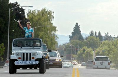 
Jeanette Delia rides in a ceremonial procession of cars Friday across the newly opened Government Way Bridge over I-90 in Coeur d'Alene. Delia owns a salon near the bridge called Klassic Kuts. For many merchants, drop-in business was at a virtual standstill during the work.
 (Jesse Tinsley / The Spokesman-Review)