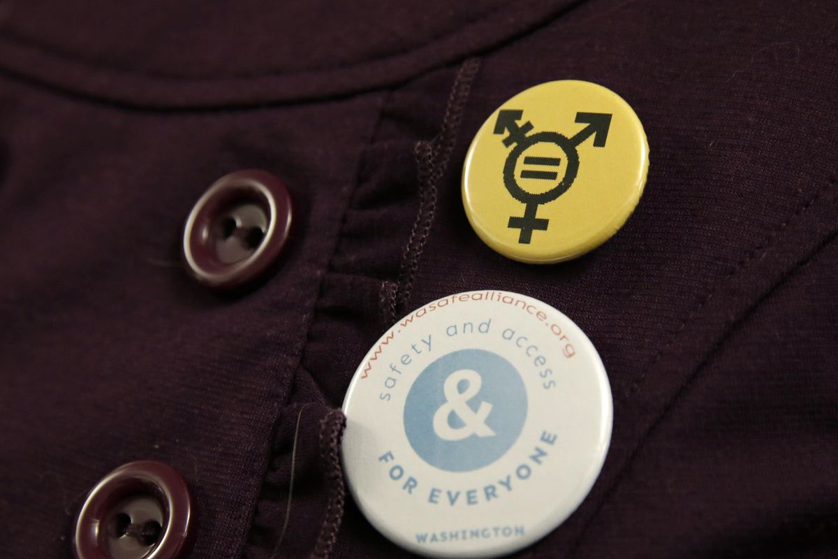 A button that reads, “Safety and Access for Everyone” is worn by a person opposing a bill that would eliminate Washington’s new rule allowing transgender people use gender-segregated bathrooms and locker rooms in public buildings consistent with their gender identity, Wednesday, Jan. 27, 2016, outside a Washington Senate hearing room at the Capitol in Olympia. (Ted S. Warren / Associated Press)