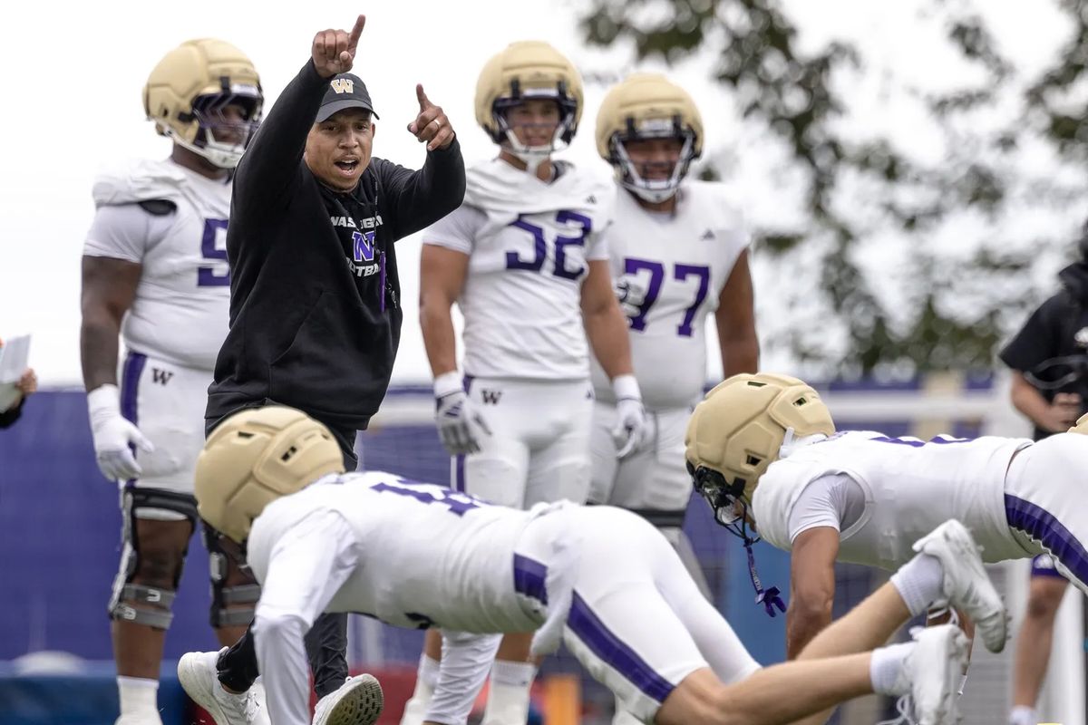 Washington defensive coordinator Ryan Walters leads defensive units in a drill during an Aug. 14 practice in Seattle. (Nick Wagner/Seattle Times)