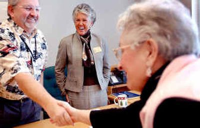 
New Kootenai County Commissioner Katie Brodie, center, watches Gus Johnson accept congratulations after he was elected as commission chairman on Monday. 
 (Kathy Plonka / The Spokesman-Review)