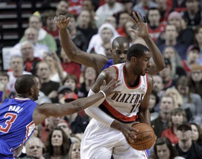 Trail Blazers forward LaMarcus Aldridge is double-teamed by the Clippers. (Associated Press)