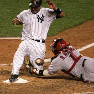 
New York's Jorge Posada scores ahead of the tag of Angels catcher Bengie Molina in the seventh inning with what turned out to be the winning run. 
 (Associated Press / The Spokesman-Review)