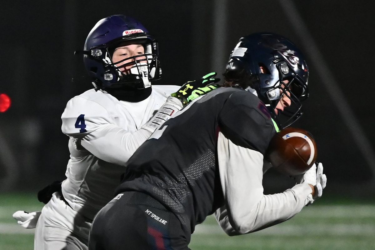 Mt. Spokane Wildcats Bradley Runge (2) gets an interception against Lake Washington Kangaroos Nathen Owens (4) in the first half at Union Stadium on Fri. Nov. 4 2022 in Spokane WA. Bradley would return the interception for a touchdown.  (James Snook)