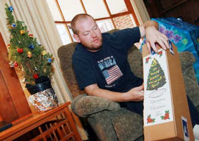 
James Ward holds a packaged Christmas tree last week in his Westminster, Md., home.  Ward  started Operation Christmas Tree. Associated Press
 (Associated Press / The Spokesman-Review)