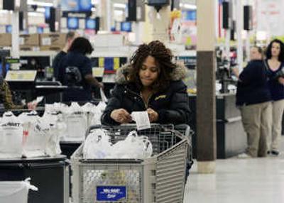 
A shopper checks her receipt at a Wal-Mart in New Jersey on Tuesday. Retail sales fell by 0.6 percent last month.Associated Press
 (File Associated Press / The Spokesman-Review)