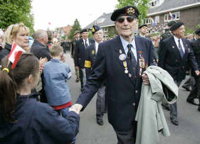 
A child sporting a Canadian flag in her hair greets a WWII veteran during a parade Thursday in the eastern Dutch town of Wageningen, Netherlands.
 (Associated Press / The Spokesman-Review)