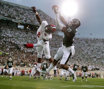 Michigan State's A.J. Troup catches a 17-yard pass for a touchdown against Jacksonville State's Jermaine Hough. (Associated Press)
