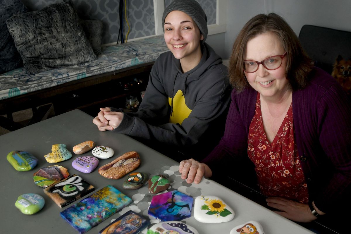 Ellie Presley, left, and Stacey Ailie of Love Rocks Art Squad Spokane are photographed at Ailie’s home in Spokane on Feb. 28. The group is painting hundreds of rocks with inspirational messages for folks at Cancer Care Northwest and are working on making hundreds more for the Garland Rock Hunt this spring.  (KATHY PLONKA/THE SPOKESMAN-REVIE)