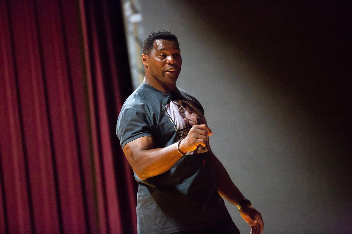 Former NFL star and Olympian Herschel Walker speaks to servicemen and servicewomen at Fairchild Air Force Base on Wednesday. The former1982 Heisman Trophy winner delivered a speech that recalled football, family, faith and reaching out for help with mental illness. (Libby Kamrowski / The Spokesman-Review)