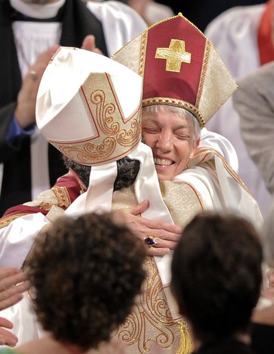 The Rev. Canon Diane M. Jardine Bruce, left, and the Rev. Canon Mary Glasspool share a hug after their consecration  Saturday. (Associated Press)