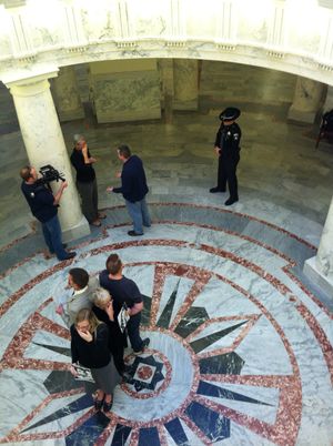 Four "Add the Words" protesters maintain a vigil in the state Capitol rotunda on Friday; near them, former Sen. Nicole LeFavour is confronted by an angry counter-protester, who was soon beckoned away by an ISP trooper (Betsy Russell)