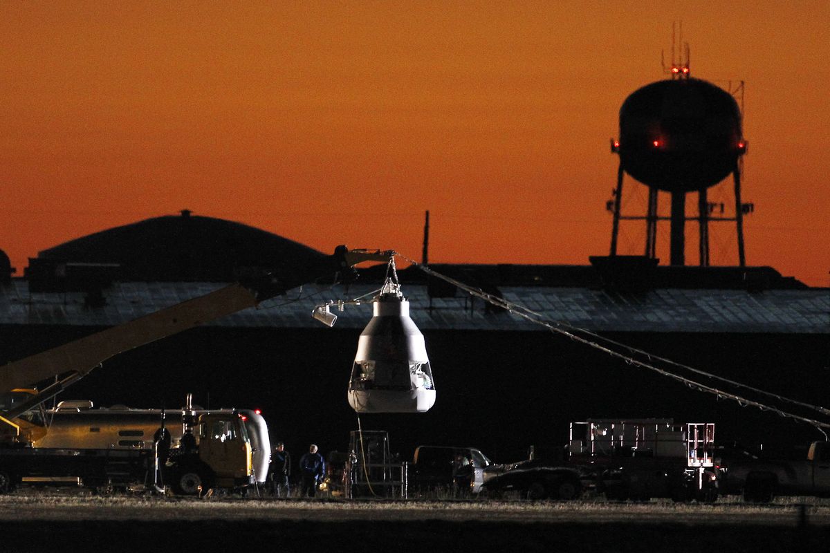 As the sun rises, workers prepare at the launch site, ahead of an attempt by Felix Baumgartner to break the speed of sound with his own body by jumping from a space capsule lifted by a helium balloon, Sunday, Oct. 14, 2012, in Roswell, N.M.  Baumgartner plans to jump from an altitude of 120,000 feet, an altitude chosen to enable him to achieve Mach 1 in free fall, which would deliver scientific data to the aerospace community about human survival from high altitudes. (Ross Franklin / Associated Press)