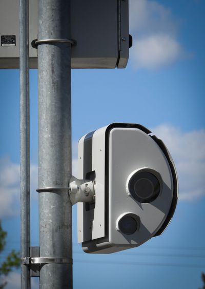 The camera portion of a speed camera system hangs on a post next to North Nevada Street, a block north of Longfellow Elementary School, shown Thursday, May 13, 2021. The camera enforcement system was placed there to slow cars when students are coming and going from Longfellow.  (Jesse Tinsley/The Spokesman-Review)