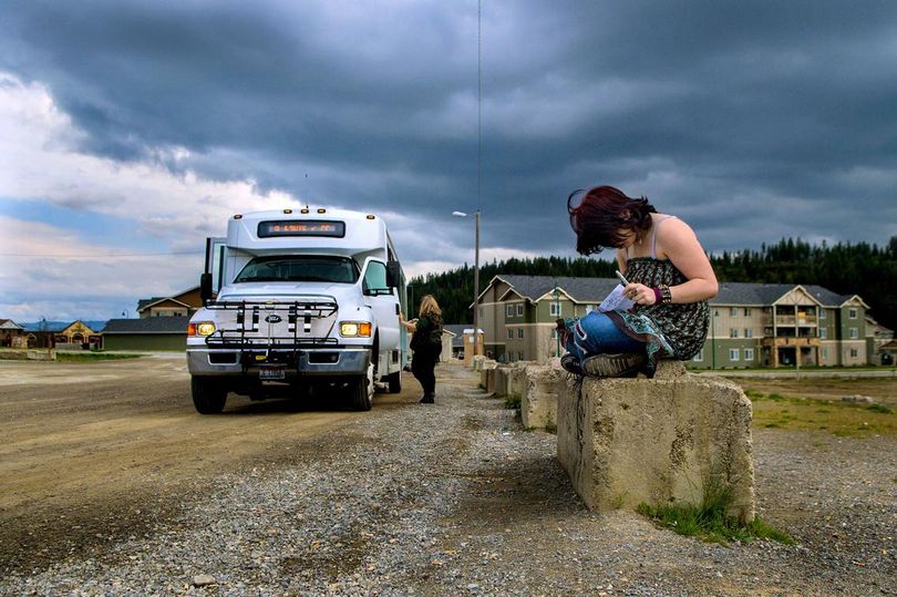 Anastasia Jackson waits for the Citylink bus to take her from the park-and-ride area near Riverstone in Coeur d’Alene to her job in Post Falls. (Kathy Plonka / The Spokesman-Review)