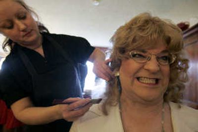 
Rose Barclay, left, a makeover and wig consultant from Portland, helps Cassie Walters  with an 