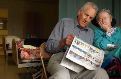 
Howard Tiffany, 89, reads the comics to his wife, Patsy, 80, at the Pinewood Terrace Nursing Center in Colville, Wash., Wednesday. Patsy has been a resident of the nursing home for three and a half years. 
 (Kathryn Stevens / The Spokesman-Review)