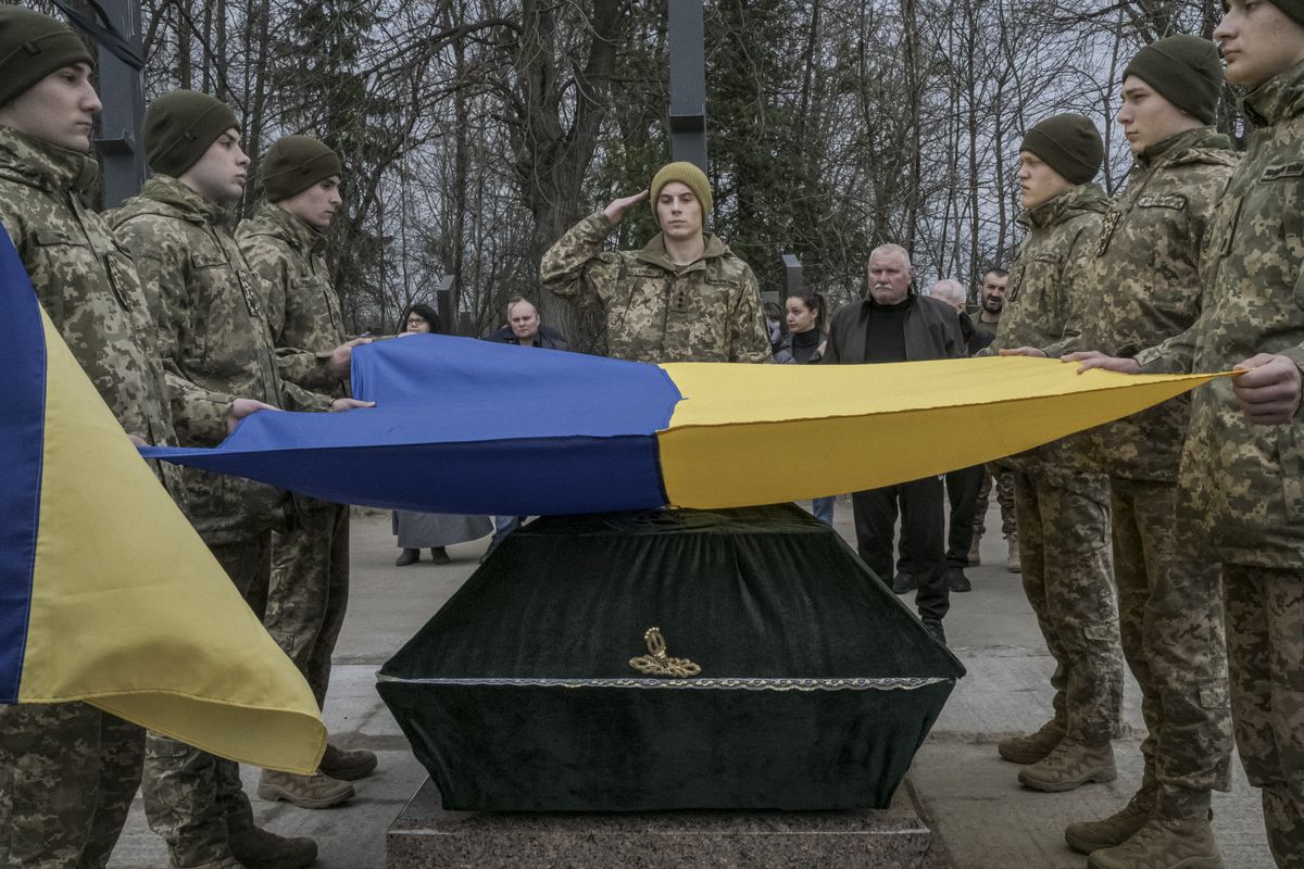Ukrainian soldiers bury a fallen comrade, Andrii Neskhodovskyi, who worked as a driver and a cook, in Kyiv, on Saturday, March 25, 2023. Ukrainian forces could be close to stabilizing the front lines in Bakhmut, the commander of the country