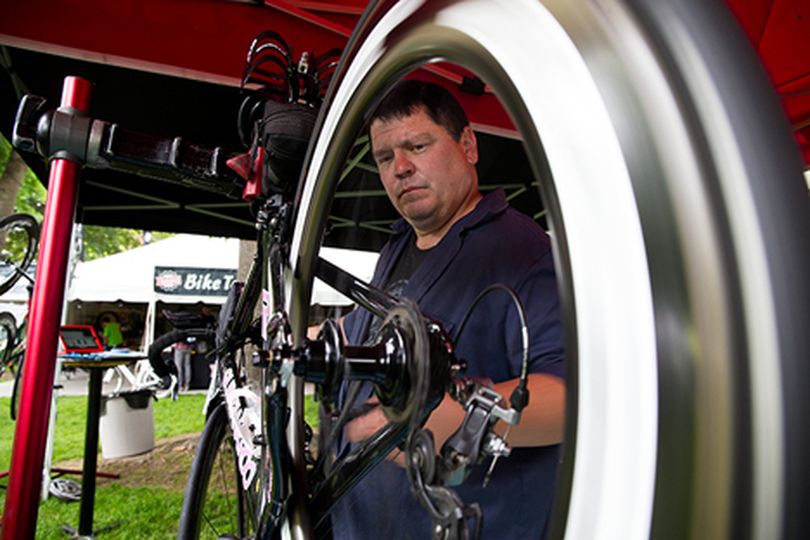 Bill McCarrick outfits a bike with rental wheels from Race Day Wheels at Ironman Village on Thursday afternoon.��Race Day Wheels rents each set for between $150 and $200 for Ironman events. (Tess Freeman/press)