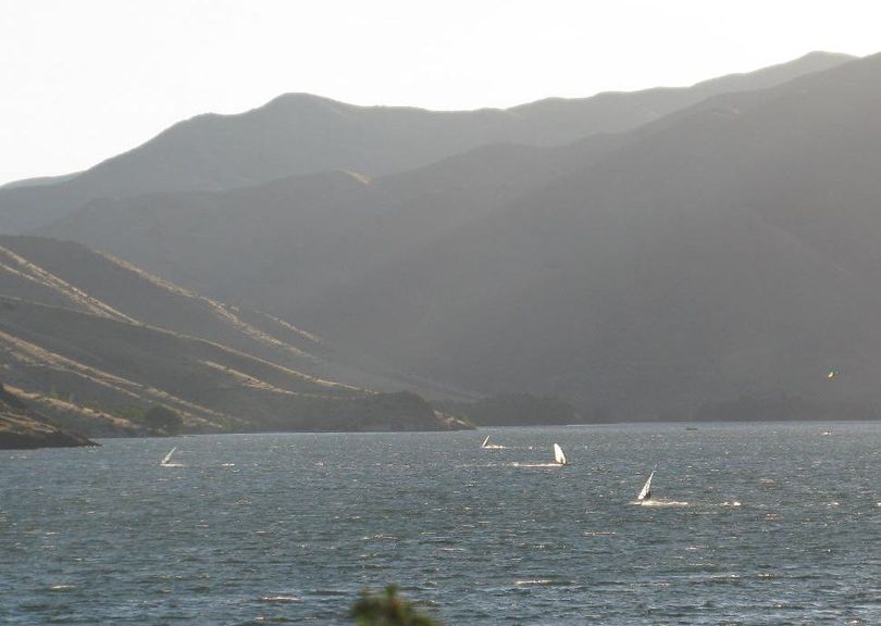 Windsurfers and kiteboarders beat the heat on Lucky Peak Lake near Boise, just after sunrise on Monday. (Betsy Russell)