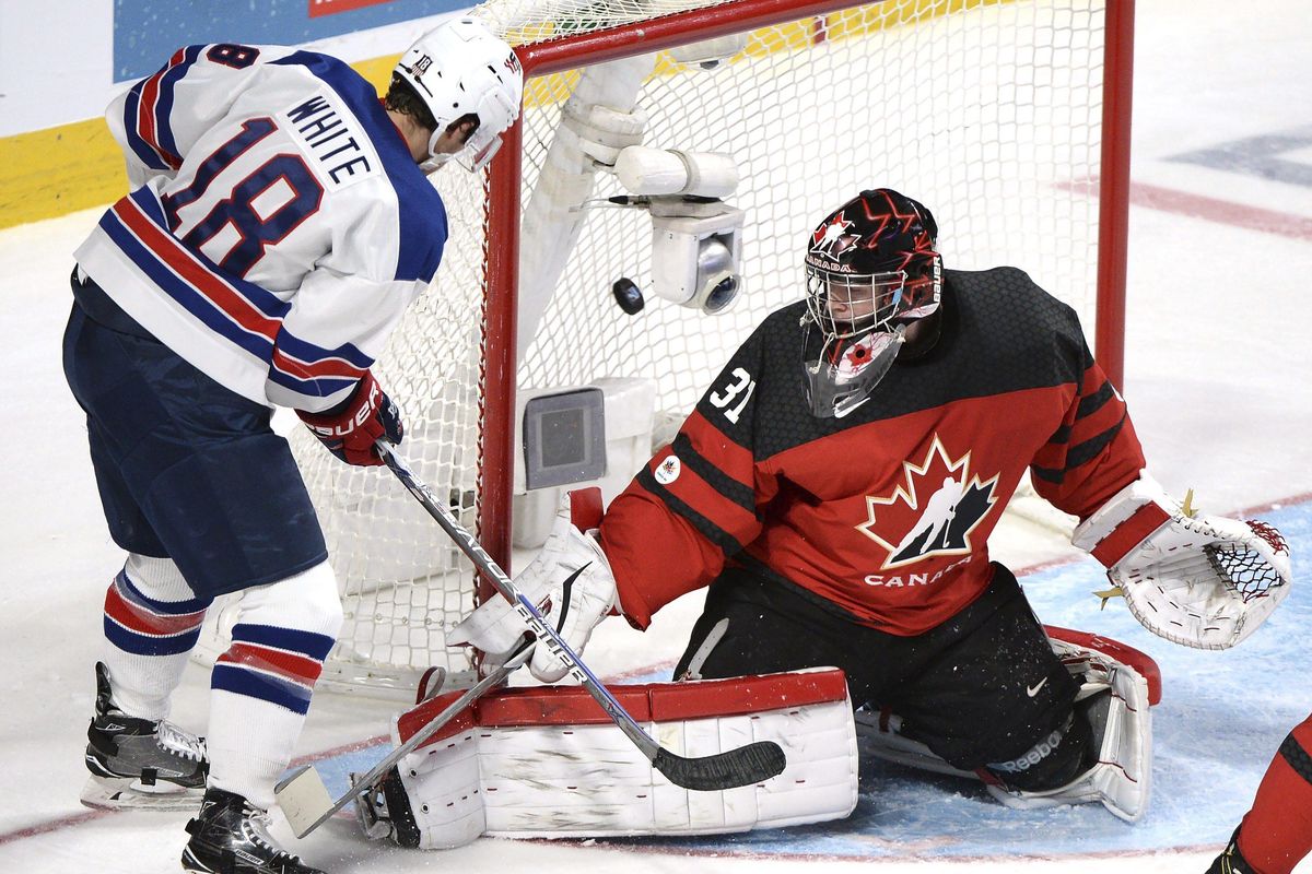 United States forward Colin White (18) scores against Canada goaltender Carter Hart (31) during the third period of the gold medal hockey game at the World Junior ice hockey championships, Thursday, Jan. 5, 2017 in Montreal. The U.S. won 5-4 in a shootout. (Paul Chiasson / Associated Press)
