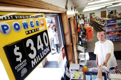
Danny Loudin buys a Powerball ticket Tuesday at the C&L Super Serve in Hurricane, W.Va., where a ticket worth $314.9 million was sold in 2002. 
 (Associated Press / The Spokesman-Review)