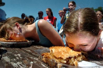 
Anika Martin, 9, right, and Sara Stiles, 16, compete in a pie eating contest in Liberty Lake Tuesday. 
 (Joe Barrentine / The Spokesman-Review)