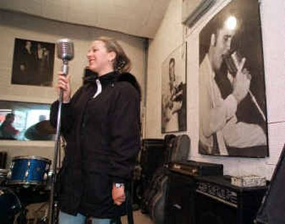 Kim Rind of Dallas, a visitor to Sun Studio in Memphis, gets a close-up look at a microphone used in the studio by Elvis Presley. Pictures of Elvis in the studio decorate the walls.
 (Associated Press / The Spokesman-Review)