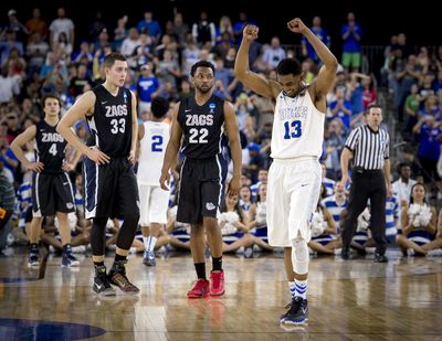 Gonzaga forward Kyle Wiltjer (33) and Gonzaga guard Byron Wesley (22) watch time run out and Duke guard Matt Jones (13) celebrate the Blue Devils 66-52 win over the Bulldogs , Sunday, March 29, 2015, in Houston, Texas. (The Spokesman-Review)