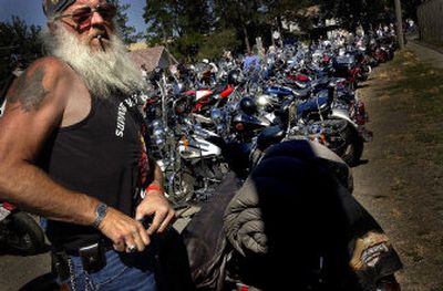 
Gene Newton tucks in his T-shirt before heading into downtown Rosalia on Saturday for the the Next Hundred Years of Motorcycles rally and show.  
 (Jed Conklin / The Spokesman-Review)