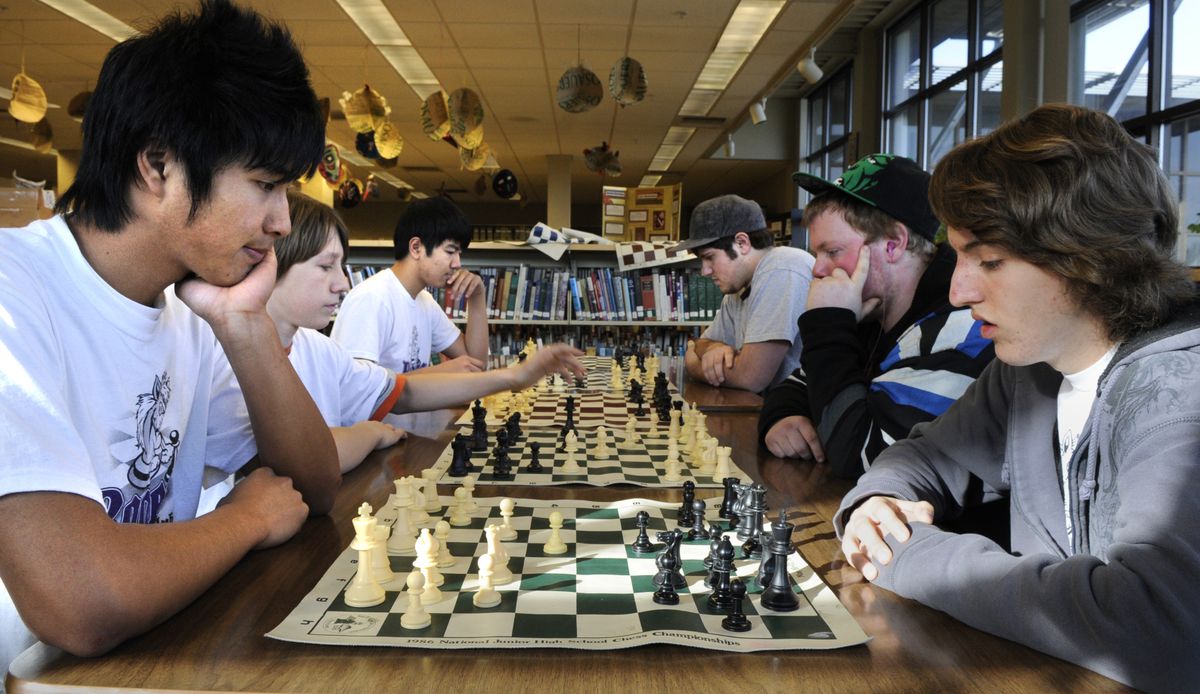 Members of Rogers High school chess club, clockwise from far left: Alex Sipraseuth, Damon Child, David Tran, James Eckart, Riqi Silva and Klint Minnameier practice before the GSL Chess Tournament March 5 at Gonzaga Prep. (Dan Pelle)