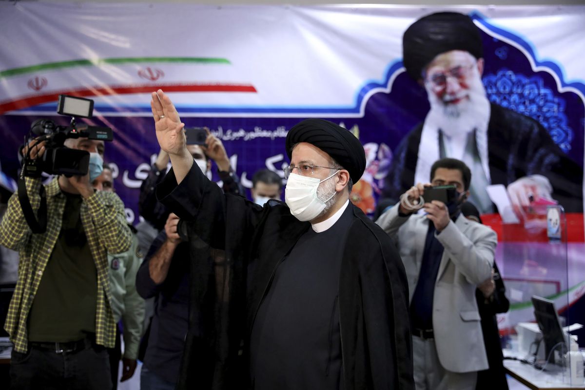 Ebrahim Raisi, head of Iran’s judiciary waves to media as he attends at the Interior Ministry to register his candidacy for the June 18 presidential elections in Tehran, Iran, Saturday.  (Ebrahim Noroozi)