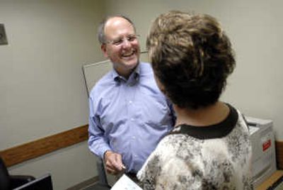 
Brian Benzel says goodbye to executive assistant Joan Poirier on his last day Friday. 
 (Brian Plonka / The Spokesman-Review)