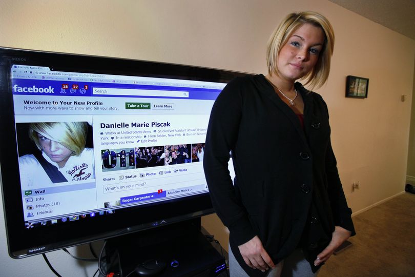 Danielle Piscak, 22, stands with her Facebook page on a monitor behind Friday, Jan. 14, 2011, in her Parkland, Wash., living room. Piscak was one of  dozens of women in the U.S. and England whose  personal information was gleaned from Facebook and then used to hack into e-mail accounts by George Bronk, who lives in the Sacramento suburb of Citrus Heights. Bronk, 23, would then send nude pictures of them to everyone in their address book. (Elaine Thompson / Associated Press)