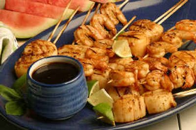 
 Grilled Scallops and Shrimp with Ginger-Limeade Pad Thai Marinade is an easy but brightly seasoned addition to grilling or broiling choices. The marinade becomes the dipping sauce served with the cooked dish.
 (Associated Press/Andre Prost Inc. / The Spokesman-Review)