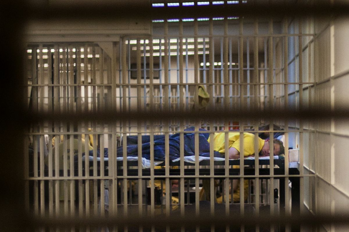 An inmate sleeps in a crowded cell in 2014 in the Spokane County Jail. As the county seeks ways to upgrade and ease overcrowding, Sheriff Ozzie Knezovich says 70 percent of the jail population is at high risk to reoffend. “We are incarcerating the worst of the worst,” he said. (Tyler Tjomsland)