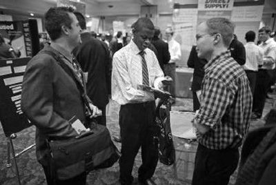 
Ejus Biakolo, center, talks with fellow Beloit College students Luke Jaynes, left, and Tim Walters at a career day event where students and companies can meet for potential jobs as well as internships. 
 (Associated Press photos / The Spokesman-Review)