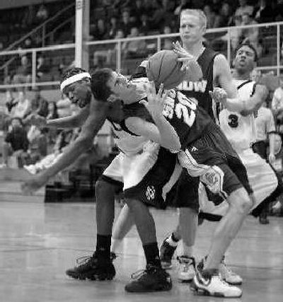 
Snow's Rick Roberts (20) and North Idaho's Steven Wesley tangle over a rebound during first-half action on Saturday in Coeur d'Alene. 
 (BRUCE TWITCHELL Special to / The Spokesman-Review)