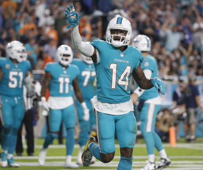 In this Sunday, Nov. 5, 2017 file photo, Miami Dolphins wide receiver Jarvis Landry (14) waves to fans after scoring a touchdown, during the second half of an NFL football game against the Oakland Raiders in Miami Gardens, Fla. The Miami Dolphins decided receiver Jarvis Landry is worth any headaches he causes, even if the cost is $16 million. Landry was given a non-exclusive franchise tag Tuesday, Feb. 20, 2018 after leading the NFL with 112 catches in 2017. The move by the Dolphins came on the first day that teams could assign franchise tags. (Wilfredo Lee / Associated Press)