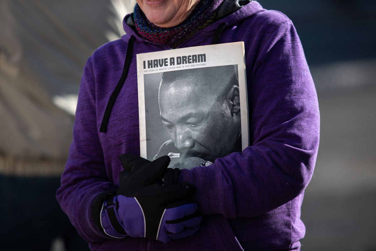 Shelley Monson holds a Martin Luther King Jr. book on Monday, Jan. 21, 2019 after the MLK day march in downtown Spokane. The event featured speeches and singing in the Spokane Convention Center before the march, and after the march there were performances in the same place. Libby Kamrowski/ THE SPOKESMAN-REVIEW  (Libby Kamrowski)