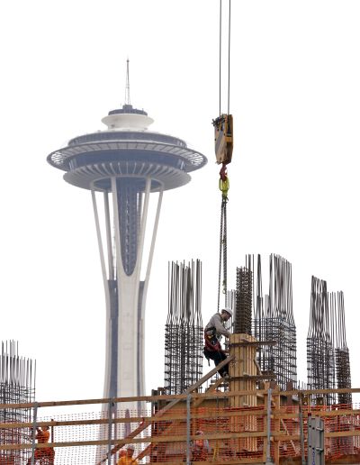 A construction worker frames a new building in view of the Space Needle in the South Lake Union area Feb. 26. (Associated Press)